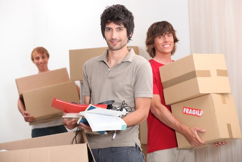 Mover carrying boxed items safely during a local relocation