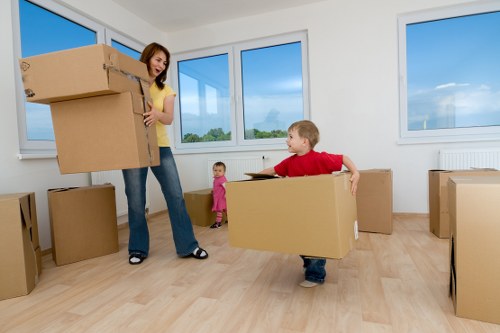 Professional movers carrying household items through a Richmond upon Thames property